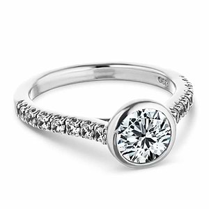  stackable engagement ring Shown with a bezel set 1.0ct Round cut Lab-Grown Diamond with accenting stones on the band in recycled 14K white gold