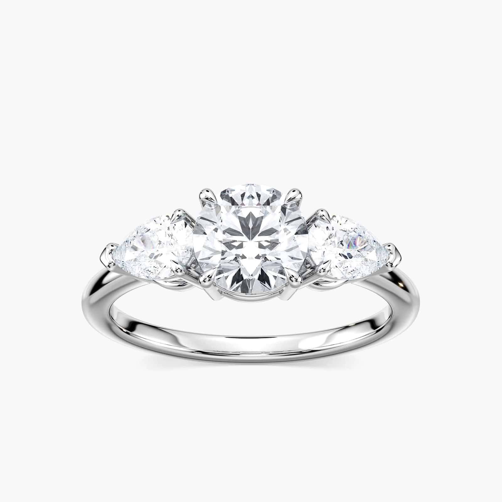 Shown with 1ct Round Cut Lab Grown Diamond Center Stone in 14k White Gold|Three stone engagement ring with 1ct round cut lab grown diamond center and 0.5ct pear cut diamond side stones in 14k white gold