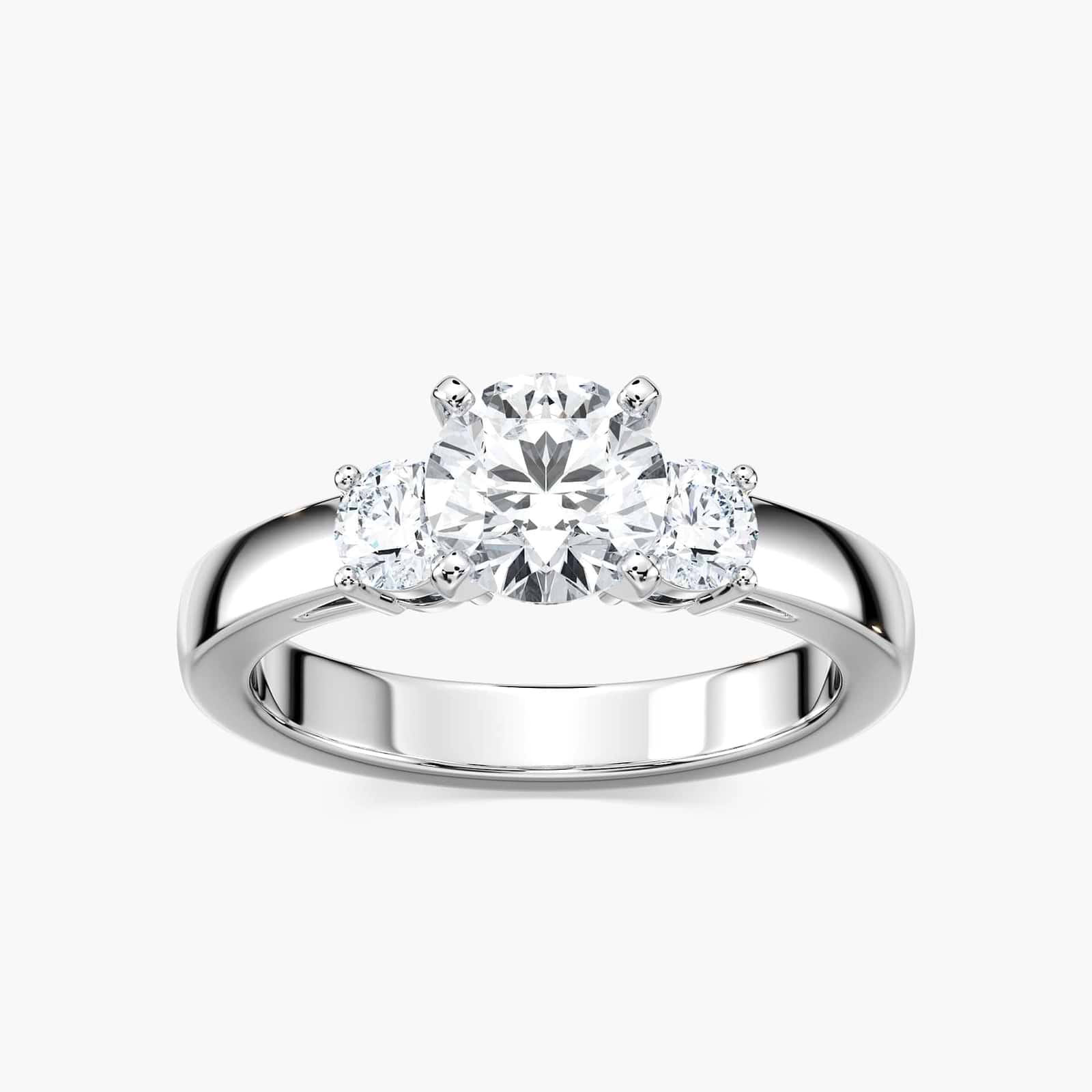 Shown with one 1ct and two 0.5ct Round Cut Lab Grown Diamonds in 14k White Gold|Elegant three stone ring with 1ct round cut lab grown diamond and two diamond shoulder stones in 14k white gold