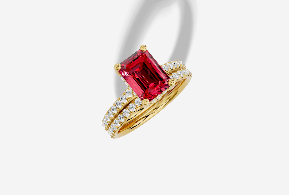 9.5 x 7.0 mm Emerald Cut Lab Grown Ruby Micro Prong Cathedral Hidden Halo Engagement Ring in 18K Gold and 0.36 ctw Matching Band