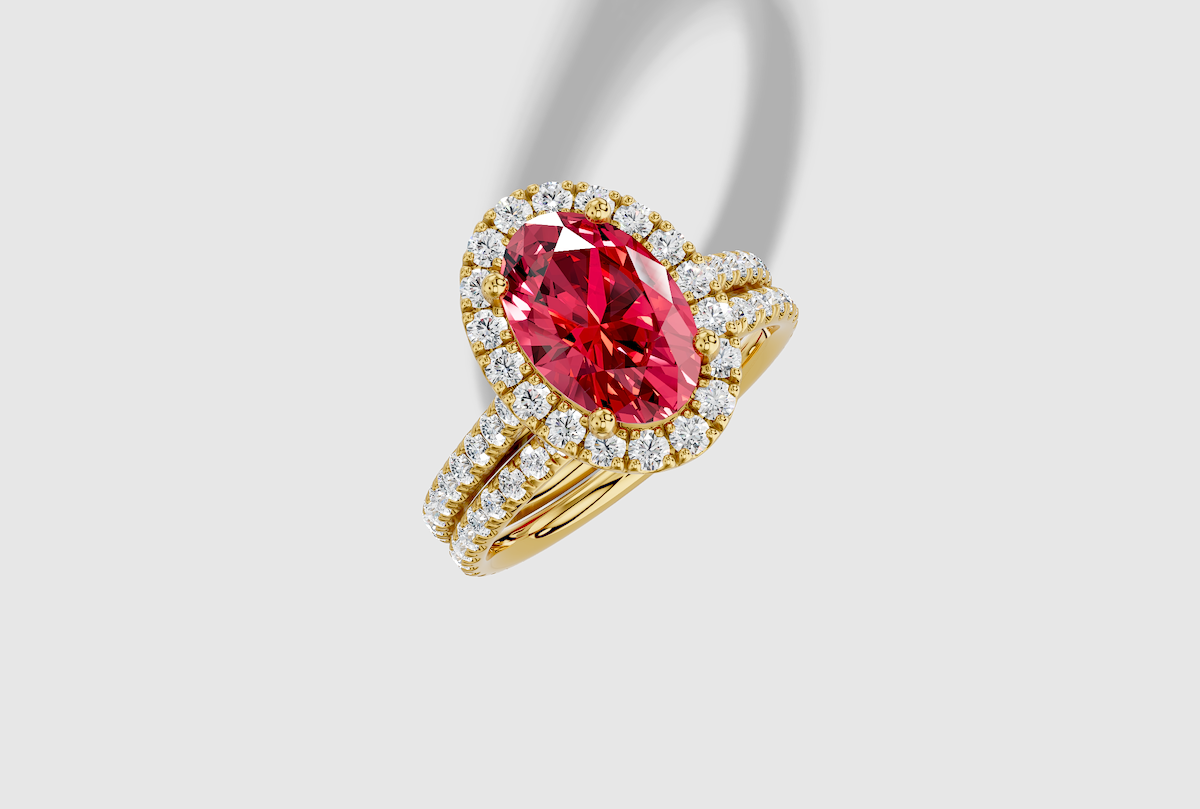 10.0 x 7.0 mm Oval Cut Lab Grown Ruby Micro Prong Cathedral Halo Engagement Ring in 18K Gold and 0.37 ctw Matching Band