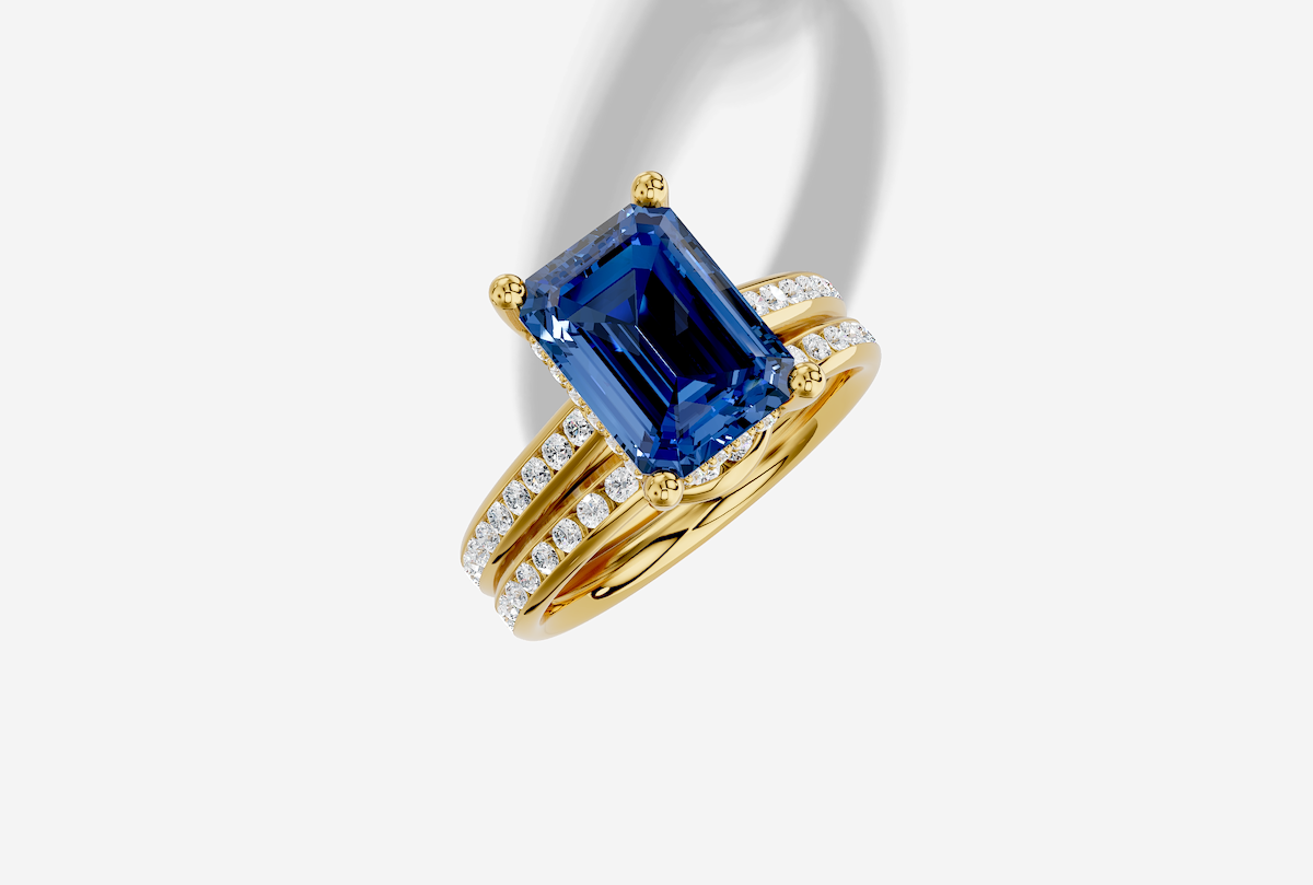 10.5 x 8.0 mm Emerald Cut Lab Grown Sapphire Channel Cathedral Hidden Halo Engagement Ring in 18K Gold and 0.35 ctw Matching Band