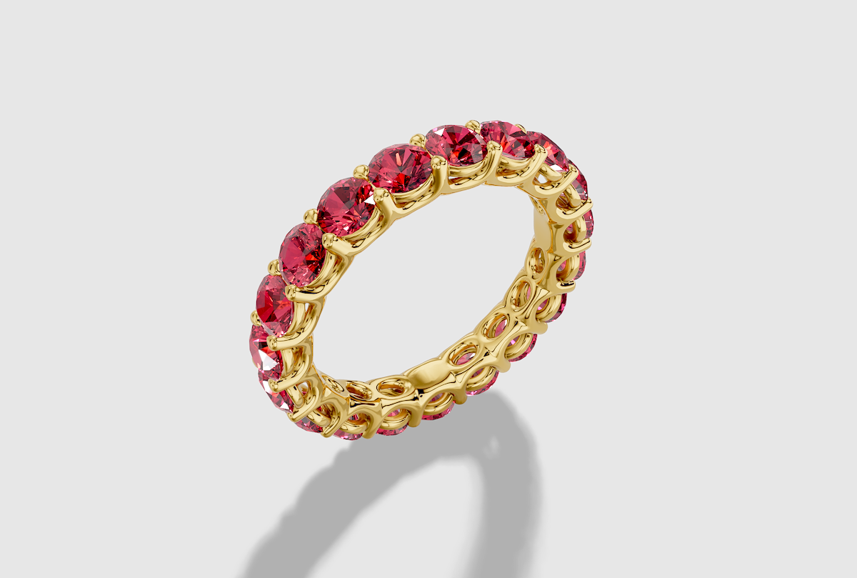 Round Cut Lab Grown Ruby Shared Prong Eternity Band in 18K Gold
