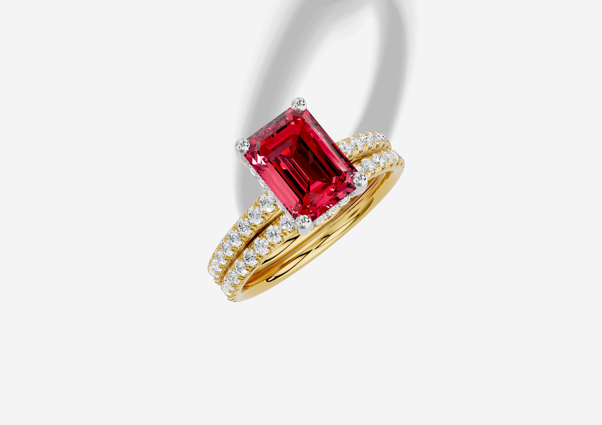 9.5 x 7.0 mm Emerald Cut Lab Grown Ruby Micro Prong Cathedral Hidden Halo Engagement Ring in 14K Gold and 0.36 ctw Matching Band