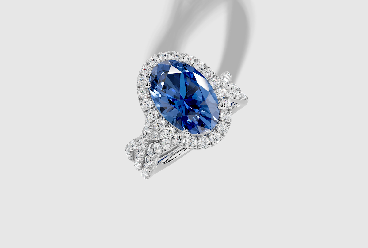 11.0 x 8.0 mm Oval Cut Lab Grown Sapphire Micro Prong Twist Halo Engagement Ring in Platinum and 0.27 ctw Matching Band
