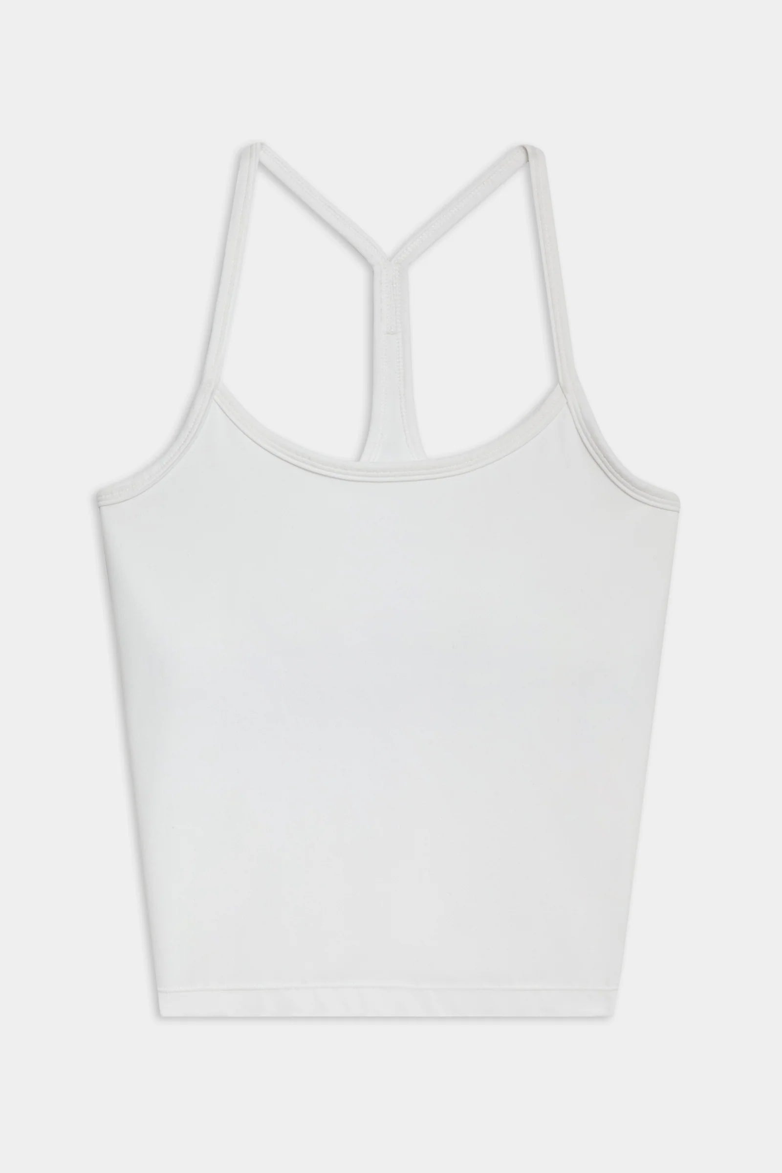 White racerback crop tank top laid flat on a plain background.