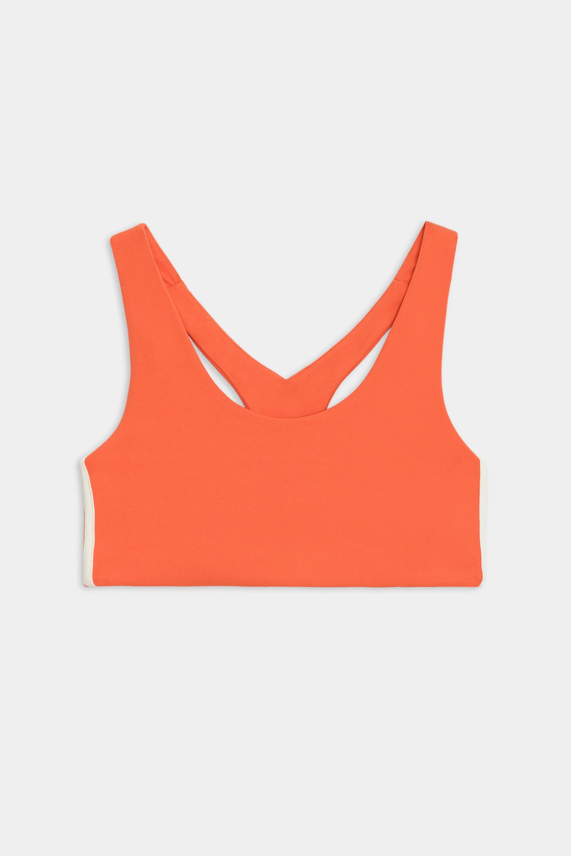 A bright orange sports bra with a racerback design, displayed against a plain white background.