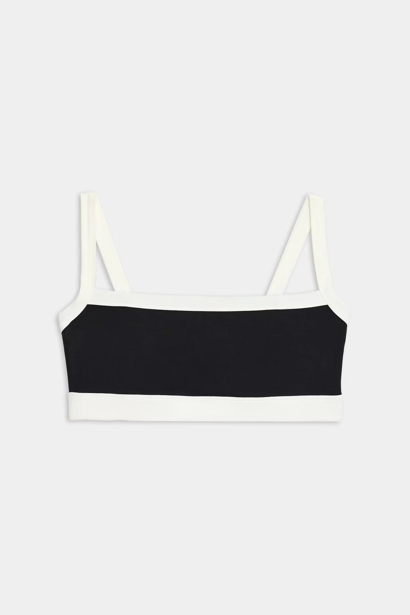A black bandeau-style crop top with white straps and white trim along the edges, displayed on a plain light background.