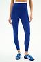 Wearing SPLITS59 Dual High Waist Airweight 7/8 leggings in Cobalt/White and blue athletic shoes, this person stands against a plain white background.