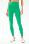 A person wears SPLITS59 Amber Airweight High Waist 7/8 leggings in Spearmint/Military, made from a soft nylon-spandex blend, paired with white sneakers against a plain white background.