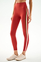 A person wearing SPLITS59 Emerson Airweight High Waist 7/8 - Terracotta/Creme leggings and beige athletic shoes stands against a white background.