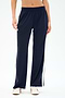 Model wears SPLITS59 Maxie Rigor Track Pant in Indigo/White—navy rigor fabric with white side stripes—paired with white sneakers, shown waist to feet against a plain background.