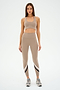 A person wearing SPLITS59's Chevron Airweight High Waist 7/8 leggings in Latte/Indigo and an ultra-luxe fabric sports bra stands on a white background.