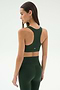 A woman models the SPLITS59 Lexi Rigor Bra in Military/Blush, paired with high-waisted leggings, standing with her back to the camera against a plain light background.