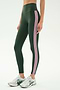 A person wearing SPLITS59's Margot Rigor Legging in Military/Blush with white athletic shoes, standing against a plain white background.