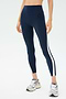 Someone wearing the SPLITS59 Miles High Waist Rigor 7/8 leggings in Indigo/White, paired with grey sneakers, stands against a plain background.