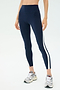 Someone wearing the SPLITS59 Miles High Waist Rigor 7/8 leggings in Indigo/White, paired with grey sneakers, stands against a plain background.