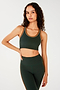 Front view of woman with dark wavy hair wearing dark green bra with white and dark orange border arm and neckline and dark green leggings with dark orange double side stripes.