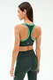 A woman is shown from the back against a plain light background, wearing the SPLITS59 Robbie Airweight Bra in Military/Spearmint.
