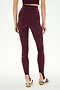 A person is shown from the back against a plain background, wearing SPLITS59 River Dual Waist Airweight Stirrup leggings in Dark Cherry/Black and white sneakers with maroon stripes.