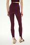 A person is shown from the back against a plain background, wearing SPLITS59 River Dual Waist Airweight Stirrup leggings in Dark Cherry/Black and white sneakers with maroon stripes.