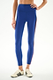 Model wears SPLITS59 Emerson Airweight High Waist 7/8 - Cobalt/Indigo leggings with a side stripe and white sneakers with black stripes, set against a plain background.