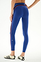 Model wears SPLITS59 Emerson Airweight High Waist 7/8 - Cobalt/Indigo leggings with red and black side stripes and white Adidas sneakers against a white background.