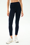 Person wearing SPLITS59 Emerson Airweight High Waist leggings in Indigo/Dove Grey and white sneakers, standing against a plain light background—ideal for Pilates or hot yoga sessions.