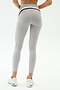 Person stands with back to camera, highlighting a sculpted look in SPLITS59 Emerson Airweight High Waist leggings in Dove Grey/Indigo and white sneakers against a plain backdrop—ideal for hot yoga or everyday wear.