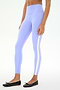 Wearing SPLITS59 Miles High Waist Rigor 7/8 leggings in Purple Haze/White with black ballet flats, a person stands against a plain white background—ideal for yoga or gym sessions.