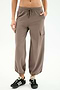 Wearing SPLITS59 Nico Airweight Cargo Pant in Lentil with side pockets and drawstring waist, paired with black sneakers—ideal for lightweight comfort during workouts, shown against a white background.
