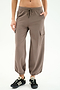 Wearing SPLITS59 Nico Airweight Cargo Pant in Lentil with side pockets and drawstring waist, paired with black sneakers—ideal for lightweight comfort during workouts, shown against a white background.