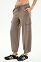 A person wears SPLITS59’s Nico Airweight Cargo Pant in Lentil, featuring a drawstring waist and side pockets, paired with black athletic shoes against a white background—ideal for workouts or casual outings.