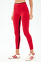 A person wears the SPLITS59 Easton Rigor High Waist 7/8 leggings in Pirate Red/Indigo, featuring a navy stripe and compressive fabric, paired with white sneakers with red stripes, standing against a plain background.
