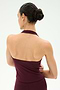 A person with dark hair in a bun is seen from behind against a plain light background, wearing the SPLITS59 June Rib Halter in Dark Cherry—a sleeveless halter top crafted from a soft modal spandex blend.