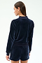 A woman is shown from the back wearing the SPLITS59 Heritage Velour Bomber in Indigo/White with matching shorts, featuring white stripes, against a plain background.