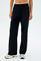 Individual wearing SPLITS59 Maxie Rigor Track Pant in Black/White paired with white sneakers against a plain background.
