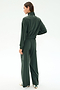 A woman stands with her back to the camera, wearing the SPLITS59 Peaches Airweight Cargo Jacket in Military, featuring soft nylon spandex, a high collar, and wide-leg pants, paired with white sneakers on a plain light background.
