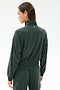 A person seen from behind, head turned left, wears the Peaches Airweight Cargo Jacket - Military by SPLITS59.