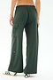 Model wearing SPLITS59’s Alex Airweight Cargo Pant in Military, featuring wide legs and side pockets, paired with white slip-on shoes with green stripes; shown from the back against a plain background.