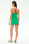 A woman faces away against a plain white background, wearing SPLITS59's Airweight High Waist 3.5” Short in Spearmint, a matching athletic tank top, and white sneakers with green stripes.