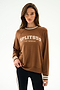 A person wears the Andie Oversized Fleece Varsity Stripe Sweatshirt - Toffee/Splits59 Los Angeles by SPLITS59 with black leggings against a plain white background.