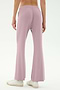 Model wears the SPLITS59 Blaire Rib Pant in Blush, showcasing the light purple flared silhouette made from soft modal-spandex, styled with white sneakers and photographed from behind against a plain backdrop.