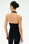 A woman stands with her back to the camera, wearing the SPLITS59 June Rib Halter in black and matching black leggings, both crafted from a soft modal blend with spandex, against a plain light background.