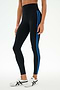 A person wearing the SPLITS59 Ella High Waist Airweight 7/8 leggings in Black/Classic Blue, paired with white sneakers, stands against a plain light background.