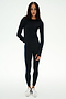 A woman stands against a plain background wearing the SPLITS59 Airweight Lite Long Sleeve Waist Length top in black—perfect attire for quick dry comfort during gym workouts.