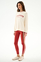 Woman in studio wears Andie Oversized Fleece Varsity Stripe Sweatshirt - Creme/Splits59 Los Angeles, red striped leggings, and beige sneakers by SPLITS59.