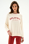 Woman wearing the Andie Oversized Fleece Varsity Stripe Sweatshirt - Creme/Splits59 Los Angeles by SPLITS59, paired with red leggings, against a plain white background.