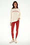 Woman in the Andie Oversized Fleece Varsity Stripe Sweatshirt - Creme/Splits59 Los Angeles, red striped leggings, and beige sneakers against a white background.