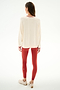 A woman faces away wearing the Andie Oversized Fleece Varsity Stripe Sweatshirt - Creme/Splits59 Los Angeles by SPLITS59, red leggings with white stripes, and light sneakers.